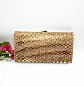 Detailed view of luxury gold evening clutch bag with sparkling rhinestone matrix texture