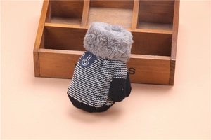 Detail of knit striped toddler mitten with soft grey faux fur trim and blue label accent