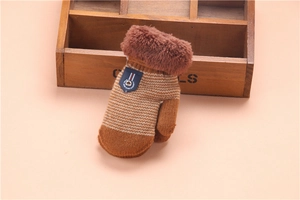 Detailed macro view of brown knitted winter gloves with soft plush cuffs and stripe patterns