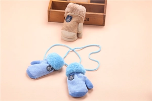 Close-up of children's thick knitted mittens with plush cuffs and anti-lost neck strings