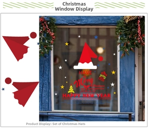 Detail of Christmas hat and star window stickers displayed on a blue vintage wooden window