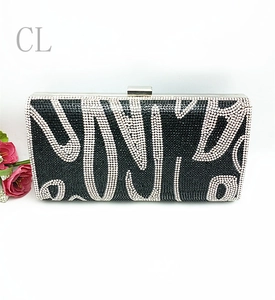 Sparkling black evening clutch bag with white rhinestone wave patterns and silver clasp