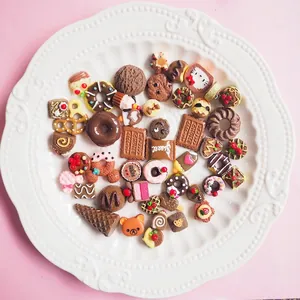 Assorted resin miniature sweets like donuts and cakes arranged in a decorative white dish