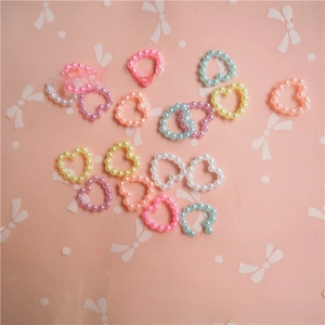 Macro detail of colorful heart-shaped pearl beads for DIY craft and phone case decor