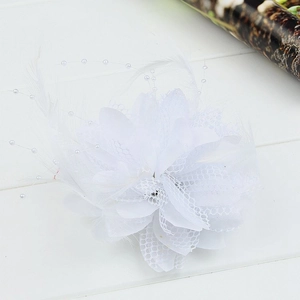 Detail of white mesh floral hair accessory with soft feathers and imitation pearls