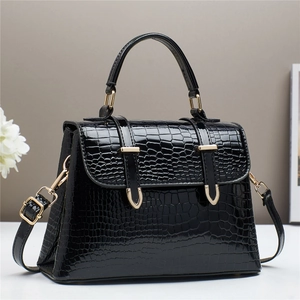 Elegant black faux crocodile skin handbag with gold D-buckles and detachable strap