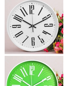 Detail view of 3D Arabic numerals and radial textured dial on colorful quartz clocks