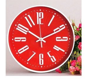 Detail of red wall clock with white 3D numbers and rose decor on pink background