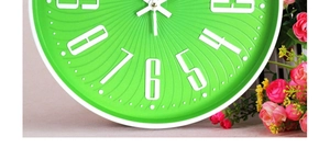 Detail of 3D embossed numbers on a green and white 12-inch modern wall clock