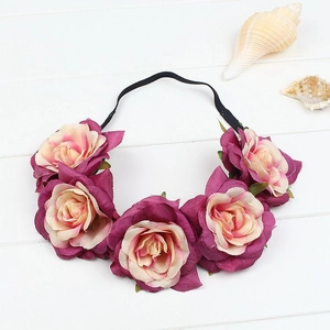 Macro view of gradient rose flowers on elastic headband against white wooden background