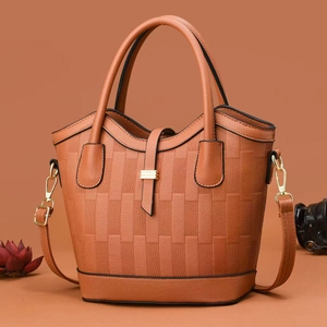Elegant orange-brown bucket bag with woven texture and gold hardware details