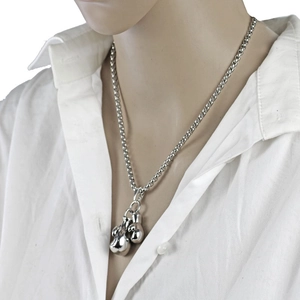 Detailed close-up of a silver stainless steel double boxing glove pendant on a cuban chain