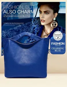 Detail of blue lychee grain leather handbag with unique hollowed-out handle design