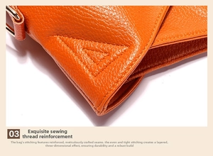 Macro shot of orange pebble leather bag featuring thick, uniform stitching detail