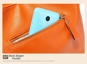 Detail view of the orange leather wing bag back zipper pocket with lychee texture