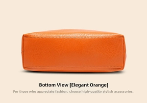 Detailed bottom view of the orange lychee grain leather bag with neat reinforced stitching