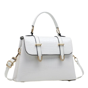 White faux crocodile leather handbag with flap closure and adjustable shoulder strap