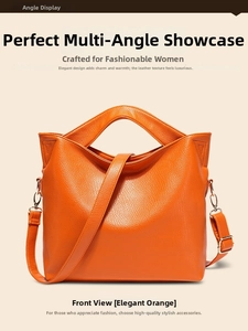 Detail shot of orange lychee grain leather texture and gold hardware on tote bag