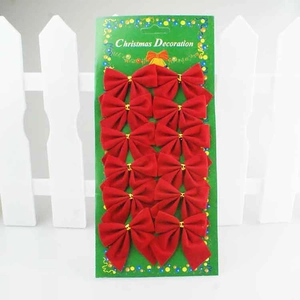 Set of 12 red flocked velvet Christmas bows in green display card packaging
