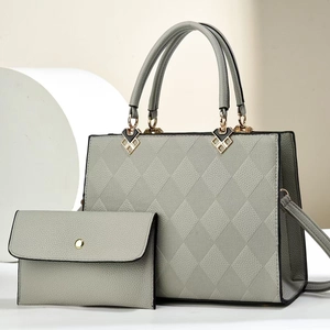 Elegant grey crossbody bag and matching wallet set with quilted pattern and gold hardware