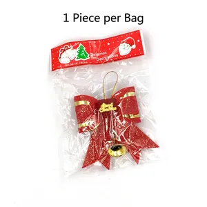 Red 3D double-layered Christmas bow ornament with gold bells and glitter on white background