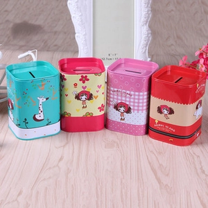 Detailed view of colorful cartoon tinplate coin purses on a warm wooden surface