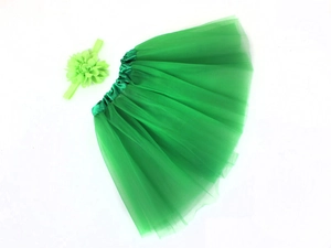 Detailed view of green chiffon tutu skirt and matching floral headband set for infants