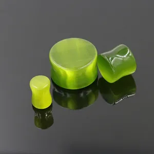Three-piece set of green cat eye stone ear plugs with polished finish and dumbbell shape