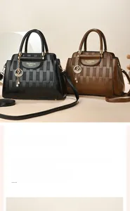 Detail of embossed plaid pattern leather bags with elegant gold pendant charms