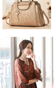 Detail of champagne gold handbag with textured faux leather and cat charm accessory