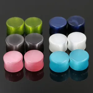 Polished cat eye stone ear plugs set in six vibrant colors for ear stretching