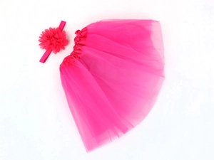 Detailed flat lay of rose red infant tutu skirt and matching floral headband set