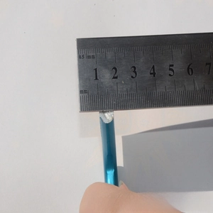 Detail shot showing 10mm diameter measurement of a blue aluminum D-ring carabiner