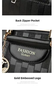 Detail of black leather bucket bag featuring gold fashion embossing and rear zip pocket