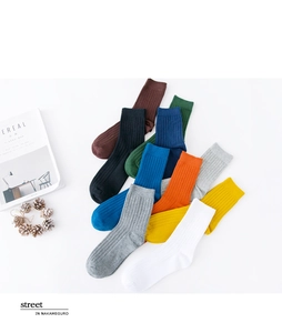 Flat lay of colorful ribbed mid-calf socks in ten vibrant colors for business casual wear