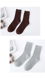 Detail of ribbed knit cotton crew socks in dark brown and light grey with textured stripes