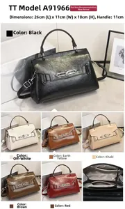 Detail view of glossy embossed leather handbag showing size 26x11x18cm and metal lock