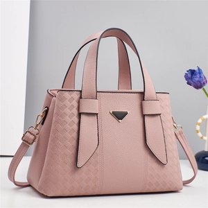 Détail du sac à main en cuir rose avec logo triangulaire et finitions dorées