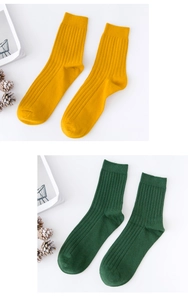 Detailed view of ginger yellow and dark green ribbed cotton socks for men