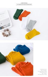 Close-up of assorted ribbed cotton crew socks in vibrant colors with a soft knitted texture