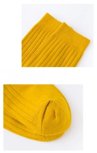 Close-up of yellow ribbed cotton business socks showing elastic cuff and toe details