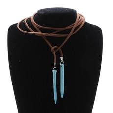 Detail of natural stone cone pendants with turquoise finish on brown leather cord