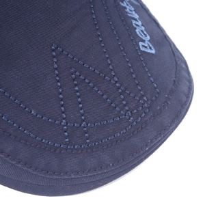 Detail of navy cotton beret featuring light blue 'Beautiful' embroidery and double stitching