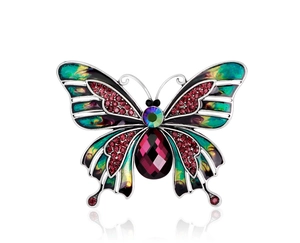 Detailed shot of enamel butterfly brooch with purple gemstone and red rhinestones