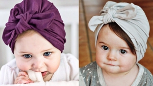 Detail of soft purple and beige baby turban hats with bow knot design for infants