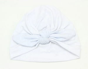 Detail of soft white cotton baby turban hat with a stylish front knot for newborns