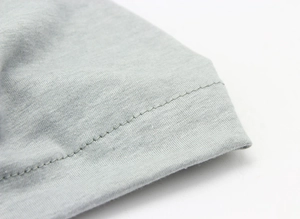 Detailed close-up showing the precise grey stitching on the edge of the cotton baby hat