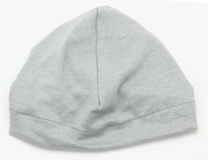 Detailed close-up of a grey knitted baby hat showing the soft cotton fabric texture