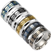Macro shot of stainless steel rings with colorful glitter inlay and skull patterns