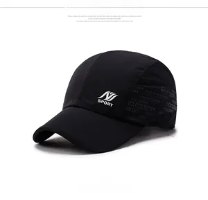 Detail of black sports cap featuring white SPORT logo and side wave print textures